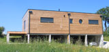 Maison en bois ECOP Habitat avec un mur à ossature bois préfabriqué