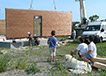 Pose d'un mur à ossature bois sur un chantier ECOP Habitat