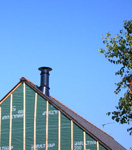 Cheminée sur une maison en bois Ecop Habitat